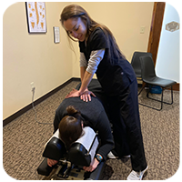 Chiropractor Windsor CO Jennifer Saboy Adjusting Patient