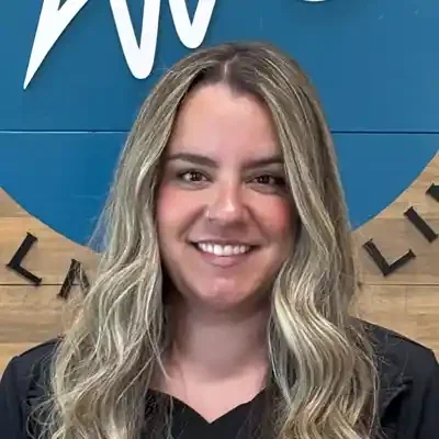 chiropractic Windsor CO Professional headshot of a smiling staff member with long wavy light-colored hair